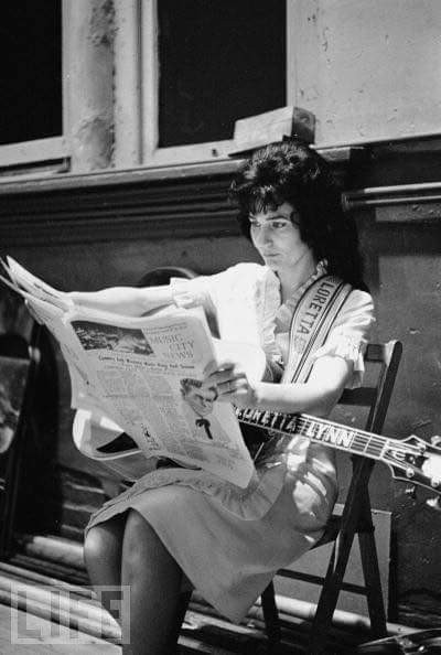 Loretta Lynn reading the paper